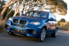 Driving 2013 BMW X5 M in Monte Carlo Blue Metallic from a front left view